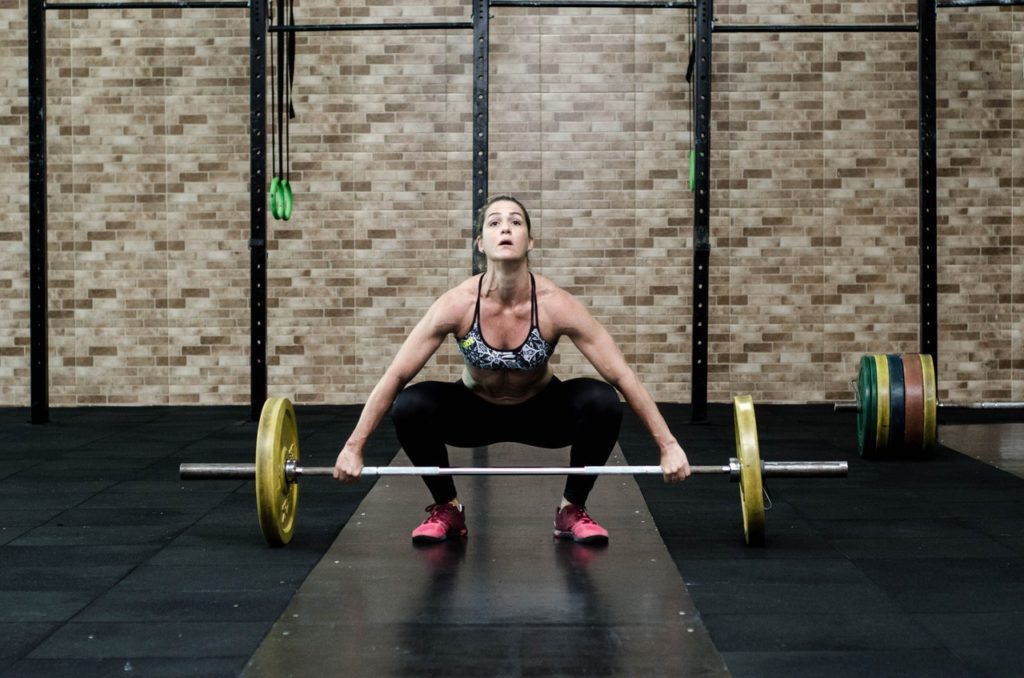 white woman dead lifting heavy yellow weights